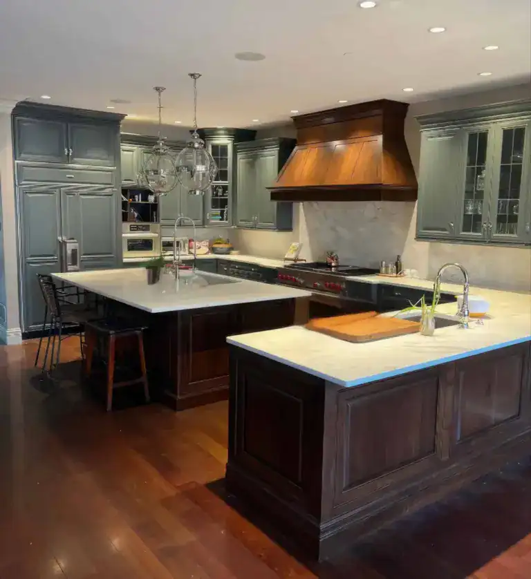 Traditional kitchen remodel with dark wood cabinetry, sage green cabinets, and stone countertops