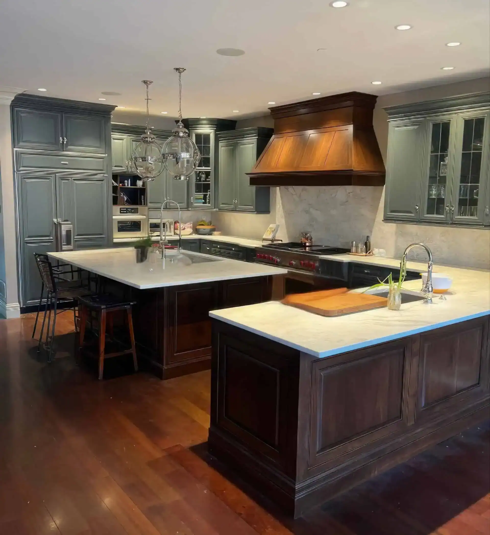 Traditional kitchen remodel with dark wood cabinetry, sage green cabinets, and stone countertops